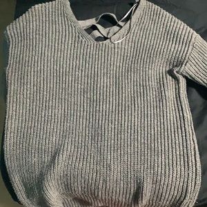 Super adorable sweater with cross up back in medium